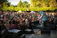 A DJ performance at an early Ogden Twilight, the amphitheater is filled with guests